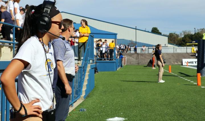 Student Worker working a game with a headset at Dix Stadium in Kent, Ohio